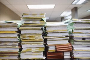 Stacks of papers emphasize the importance of document processing automation. 